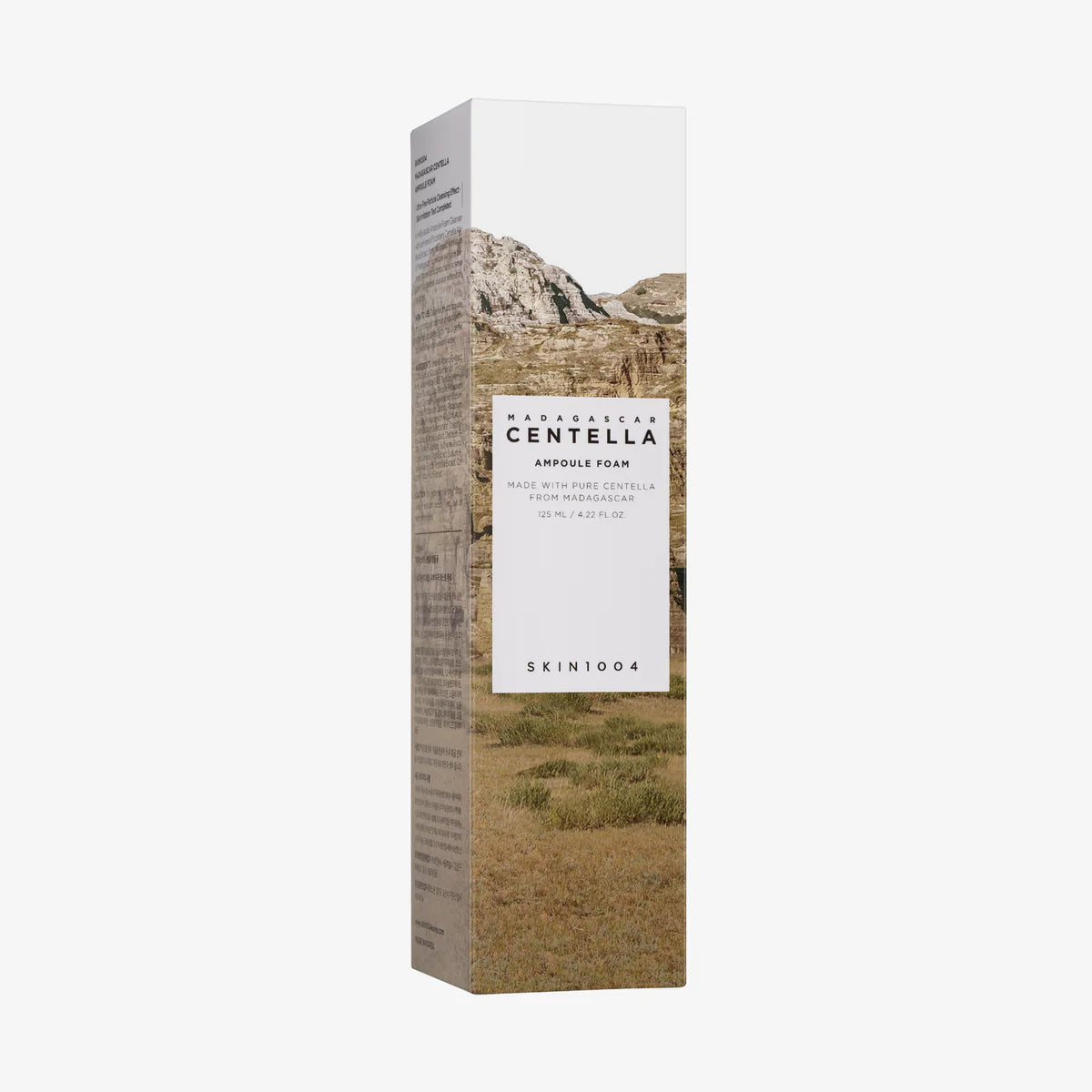 Verpackung: Gold-weiße Kartonverpackung mit Landschaftsmotiv.