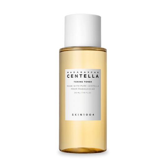 Transparente Flasche mit goldenem Toner und weißem Deckel.