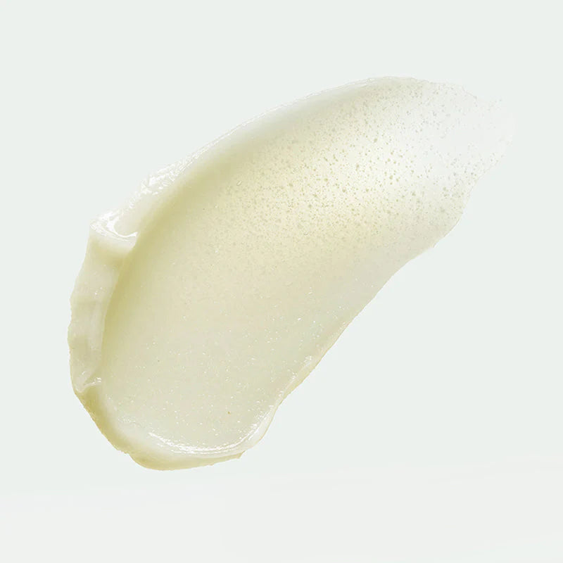 Cremeartige Gelstruktur mit feinen Peelingpartikeln auf hellem Hintergrund.