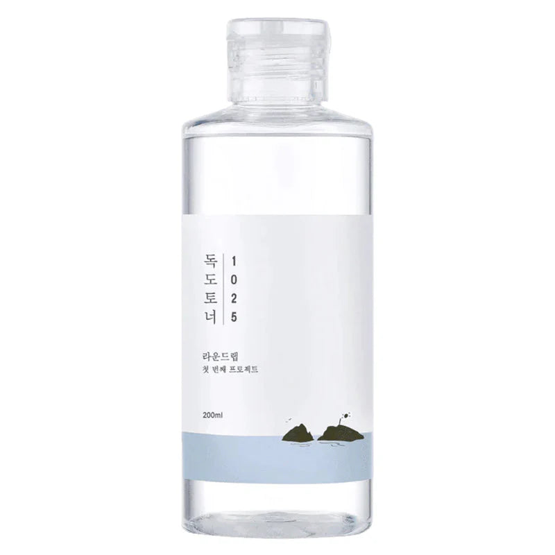 Klare Flasche mit schlichtem Design, 200 ml, weiße Etikette mit minimalistischer Illustration von Felsen.